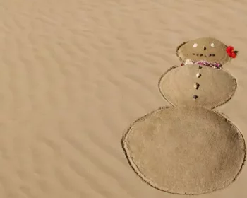 A snow man drawn in sand.