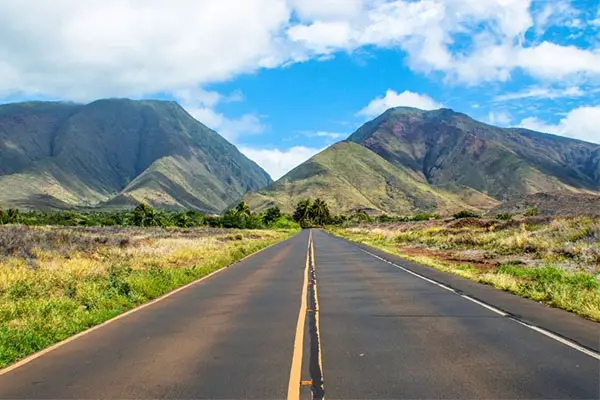 Open road heading towards the mountains in Maui. 