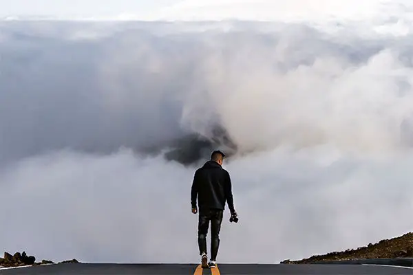 Solo traveler walking along road along Haleakala on Maui.