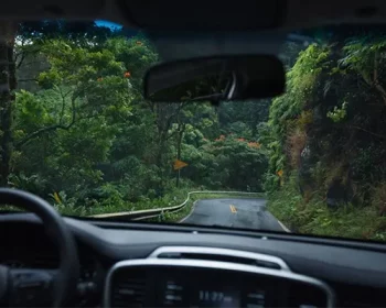 Dashboard view of a car driving along a road in Maui.