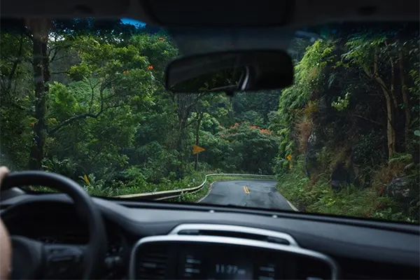 Dashboard view of a car driving along a road in Maui. 