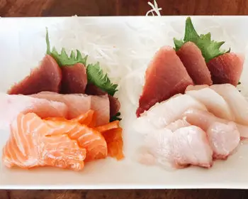 Sashimi on a white dinner plate.