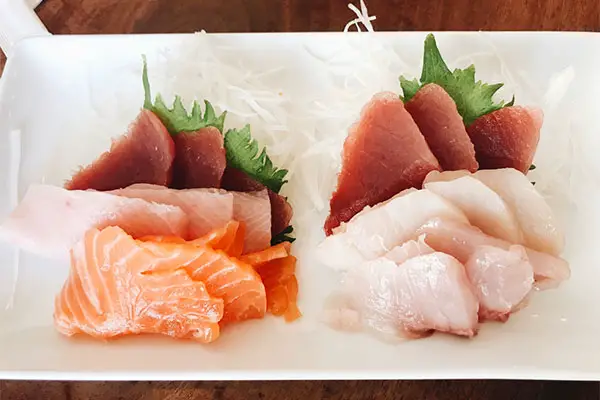 Sashimi on a white dinner plate. 