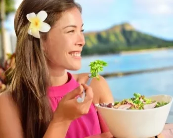 Woman eating salad at a restaurant in Hawaii