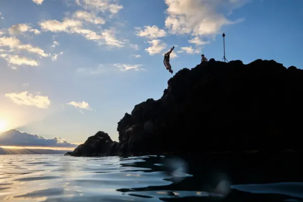 Diver jumping into ocean from Black Rock