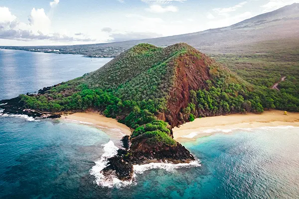 Aerial view of an island covered in vegetation.