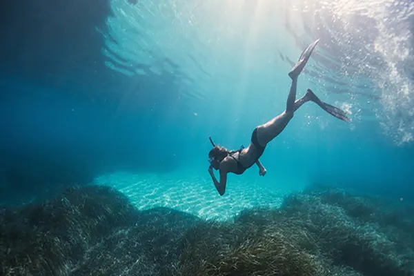 Woman snorkeling underwater.