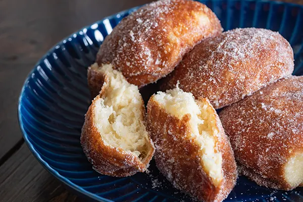 Malasada donuts. Sweet sweets made by sprinkling sugar on fried bread.