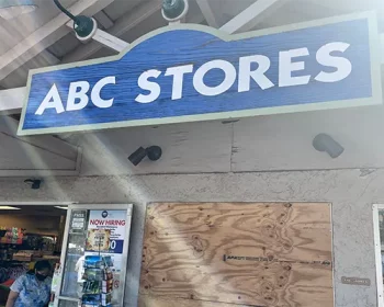 Outside a ABC Store in Maui, the wooden sign.