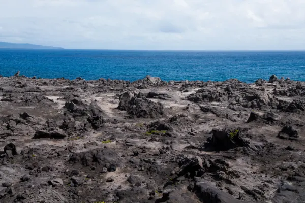 Lava fields in Maui by the ocean.