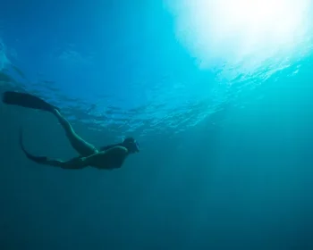 Woman snorkeling underwater.