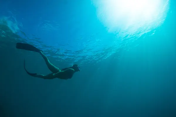 Woman snorkeling underwater.