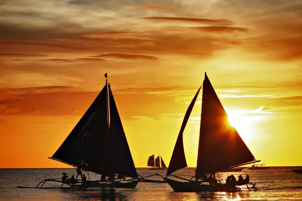 Two sailboats at sunset. 