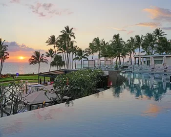 View of a resort pool at sunset,