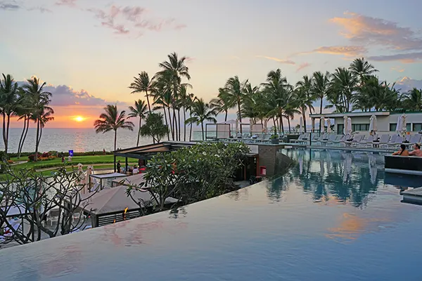 View of a resort pool at sunset,