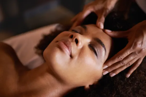Woman receiving temporal massage. 