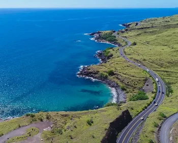 An aerial view of a long coastal highway in West Maui, Hawaii to the south of Lahaina.