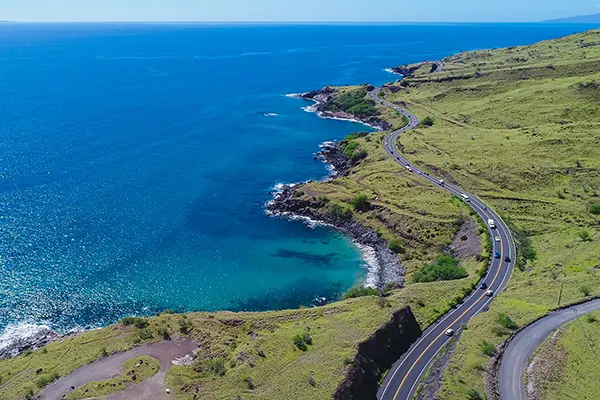 An aerial view of a long coastal highway in West Maui, Hawaii to the south of Lahaina.