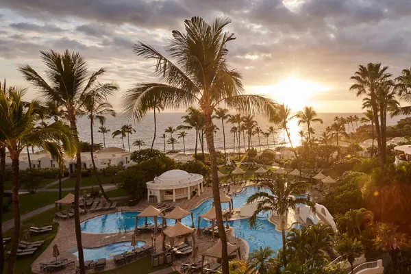 Sunset view of a resort pool. 