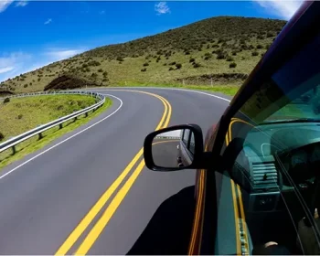 Car driving on a mountain road in Maui.
