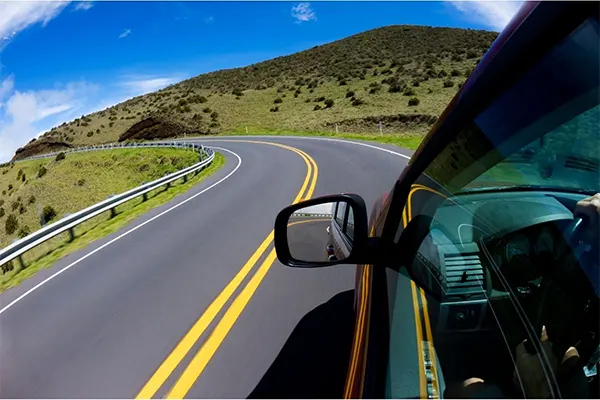 Car driving on a mountain road in Maui.