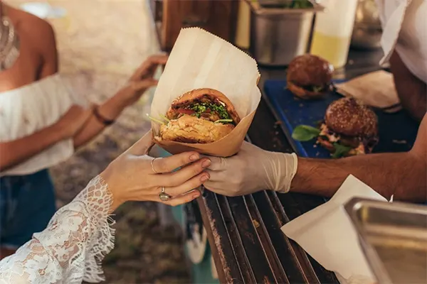 Person receiving their order at a food truck. 