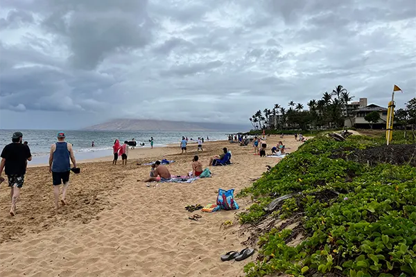 People hanging out on the beach at Kamaole Beach Park 2. 
