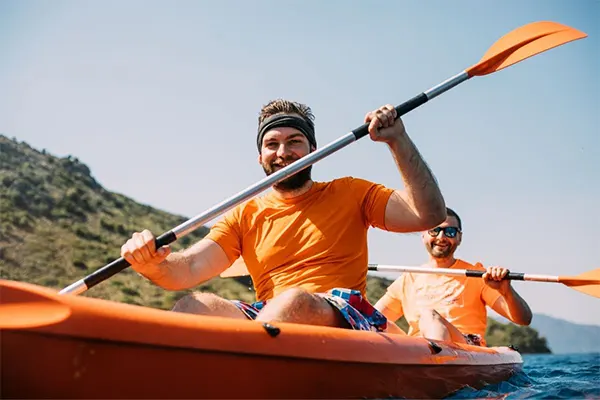 Man smiling while kayaking. 