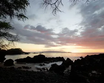 A rocky beach at sunset.