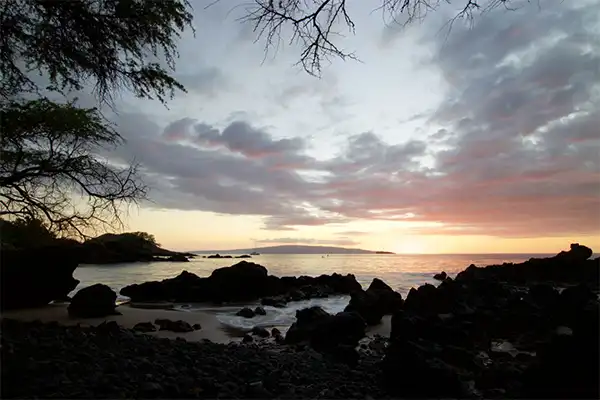 A rocky beach at sunset.