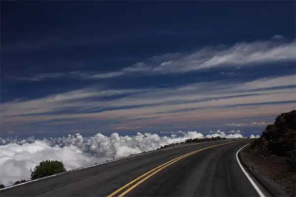 Road winding around Haleakala above the clouds in Maui.