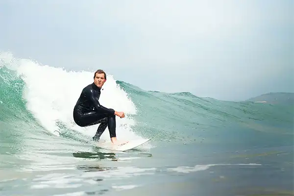 Man surfing a small wave in Maui. 