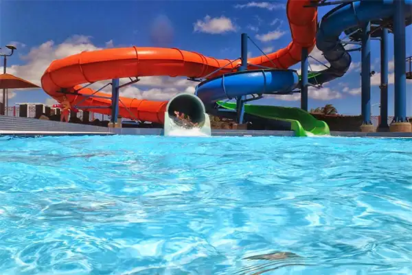 Waterslides at a resort snaking into a pool. 