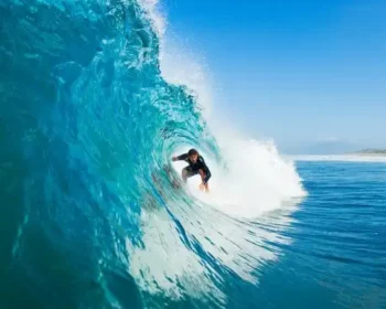 Man surfing a tubular wave in the Maui ocean.